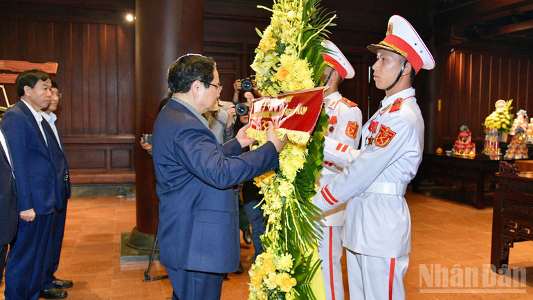 Thủ tướng Phạm Minh Ch&iacute;nh chỉnh hoa trước khi thực hiện nghi lễ d&acirc;ng hương, d&acirc;ng hoa tưởng nhớ c&aacute;c Anh h&ugrave;ng liệt sĩ chiến trường Điện Bi&ecirc;n Phủ. (Ảnh: THANH GIANG)