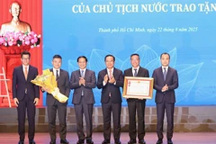 Phó Thủ tướng, Bộ trưởng Ngoại giao Bùi Thanh Sơn thừa ủy quyền của Chủ tịch nước trao tặng Huân chương Lao động hạng Nhất cho Sở Ngoại vụ Thành phố Hồ Chí Minh. (Ảnh: NGÔ TÙNG).