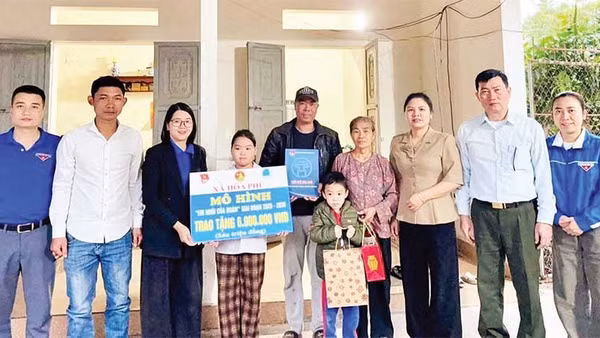 Chị Lê Thị Mỹ, Bí thư Đoàn Thanh niên xã Hòa Phú (người thứ ba từ trái sang) trao kinh phí hỗ trợ từ mô hình “Em nuôi của Đoàn” cho em Nguyễn Thị Chiêu Dương, thôn An Mỹ.