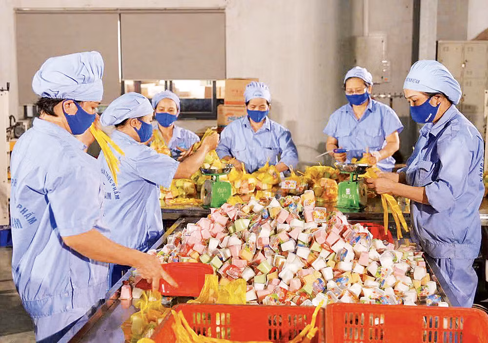 Công nhân Nhà máy Vietfoods (Khu công nghiệp Hapro, Hà Nội) trong xưởng sản xuất.