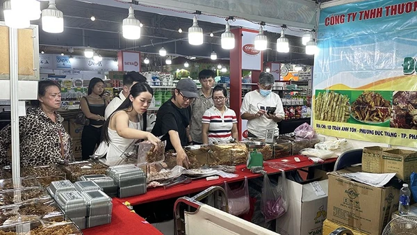 Khách du lịch nước ngoài tham quan và mua sắm hải sản khô tại một gian hàng trong chiều ngày 17/11.