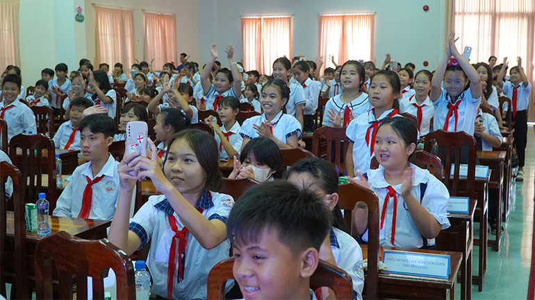 Học sinh giao lưu với bạn mèo máy Doraemon. (Ảnh: HỮU NGHĨA)