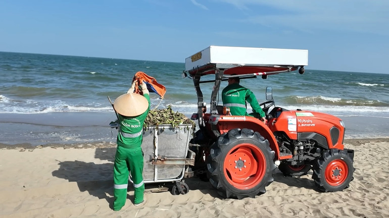 Công nhân môi trường thu gom rác trên bãi biển.