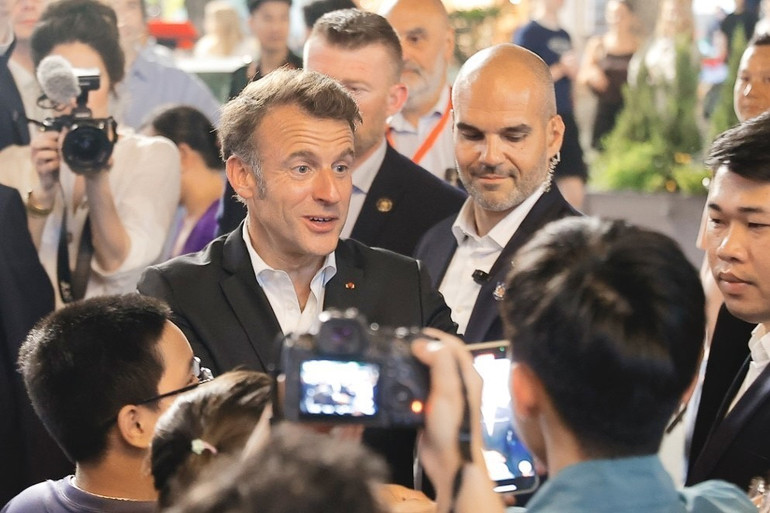 Tổng thống Pháp và Phu nhân gặp gỡ người dân trên đường tản bộ khu vực phố cổ Hà Nội. (Ảnh: TTXVN)