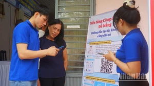 Thanh niên tình nguyện hướng dẫn người dân cài đặt ứng dụng Danang smart city.