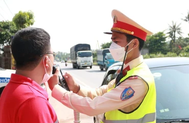 Lực lượng chức năng kiểm tra nồng độ cồn đối với người điều khiển phương tiện. (Ảnh: Đức Cường)