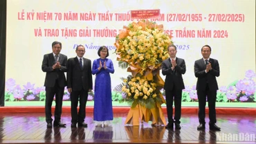 Đồng chí Nguyễn Văn Quảng, Ủy viên Ban Chấp hành Trung ương Đảng, Bí thư Thành ủy, Trưởng đoàn Đại biểu Quốc hội đơn vị thành phố Đà Nẵng và Phó Bí thư Thường trực Thành ủy Nguyễn Đình Vĩnh trao tặng lẵng hoa chúc mừng Ngành y tế Đà Nẵng nhân ngày 27/2. (Ảnh: ANH ĐÀO)