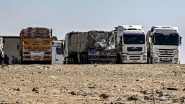 Xe tải chở hàng viện trợ cho Dải Gaza tập trung gần cửa khẩu Rafah bên phía Ai Cập, ngày 23/3. (Ảnh: AFP/TTXVN)