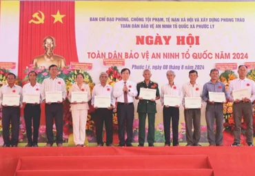 Phó Ban Tuyên giáo Trung Ương Phan Xuân Thủy tặng quà của Trung ương cho người có công, gia đình chính sách trên địa bàn xã Phước Lý, huyện Cần Giuộc, Long An.