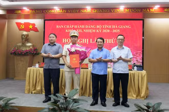 Các đồng chí lãnh đạo tỉnh Hà Giang trao quyết định và tặng hoa chúc mừng Đại tá Nguyễn Đức Thuận, Giám đốc Công an tỉnh Hà Giang.