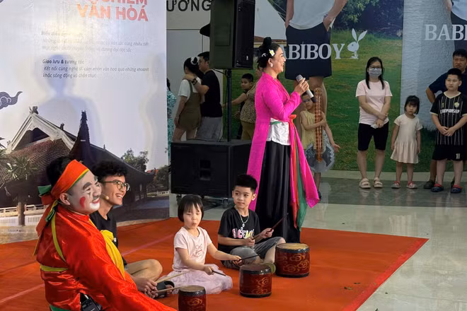 Các em thiếu niên, nhi đồng trải nghiệm nghệ thuật chèo với sự hướng dẫn của nghệ sĩ.