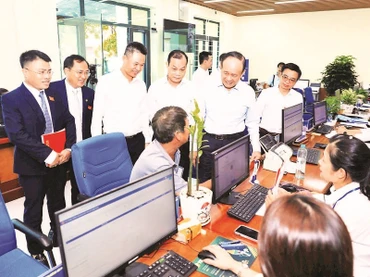 Lãnh đạo thành phố Hà Nội trao đổi với người dân đến làm thủ tục hành chính tại điểm Phục vụ hành chính công xã Phú Xuyên. (Ảnh LÊ HẢI)
