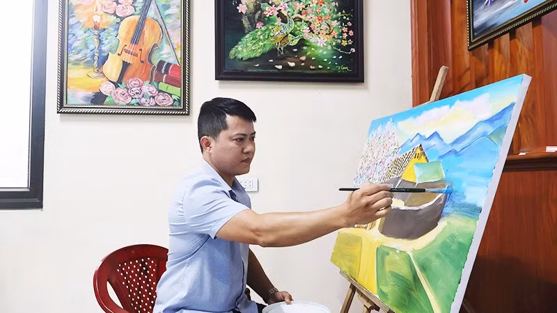 Cao Thanh Nam với bức tranh đang sáng tác.