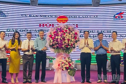 Bí thư Tỉnh ủy Lào Cai Trịnh Xuân Trường tặng hoa chúc mừng hội nghị. (Ảnh: THANH SƠN)