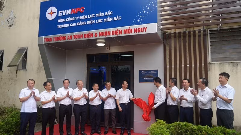 Các đại biểu thực hiện nghi thức gắn biển - khánh thành Thao trường an toàn điện và nhận diện mối nguy. (LÊ CHI)