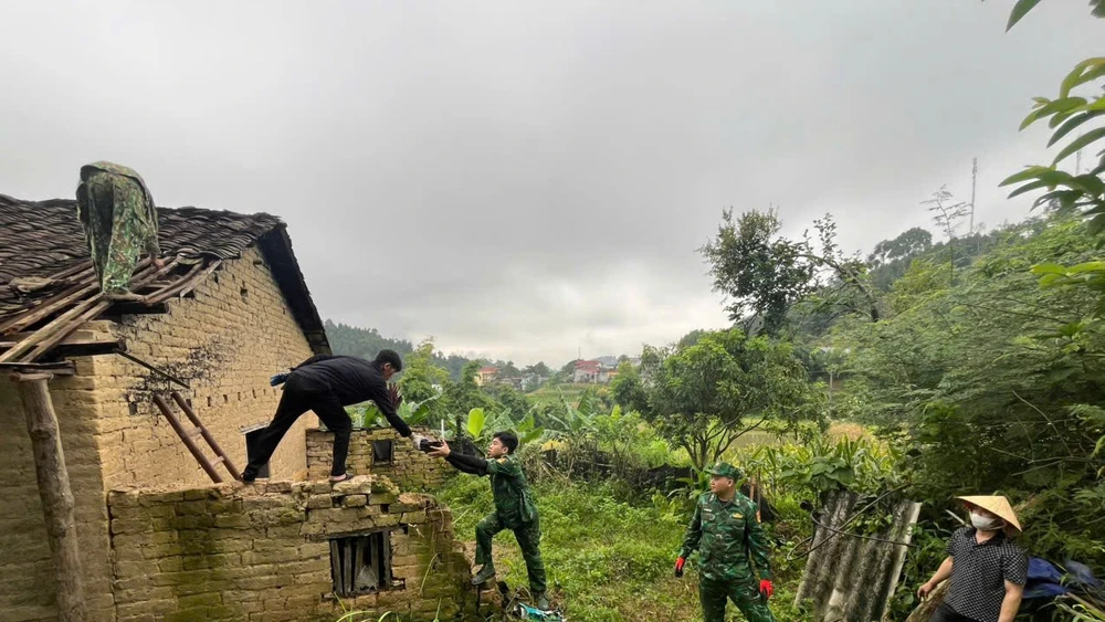 Cán bộ chiến sĩ biên phòng giúp đỡ xây sửa nhà cho người dân.