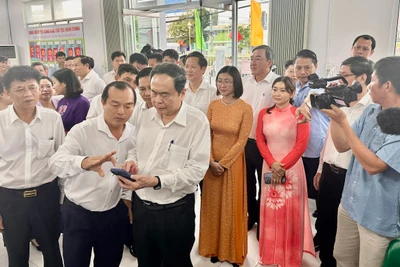 Chủ tịch Quốc hội trao đổi với cán bộ trung tâm giải quyết thủ tục hành chính tại phường Phú Lợi về cách thức ứng dụng, khai thác trí tuệ nhân tạo trong xử lý công việc.