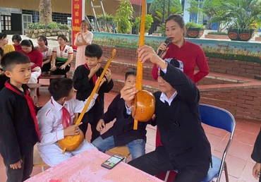Nghệ nhân Thùng Văn Đôi giới thiệu các bộ phận cây đàn tính của đồng bào dân tộc Thái đến học sinh Trường phổ thông dân tộc bán trú tiểu học Chà Nưa. 