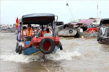 Thuyền chở du khách tham quan chợ nổi Cái Răng (Ảnh: TTXVN)