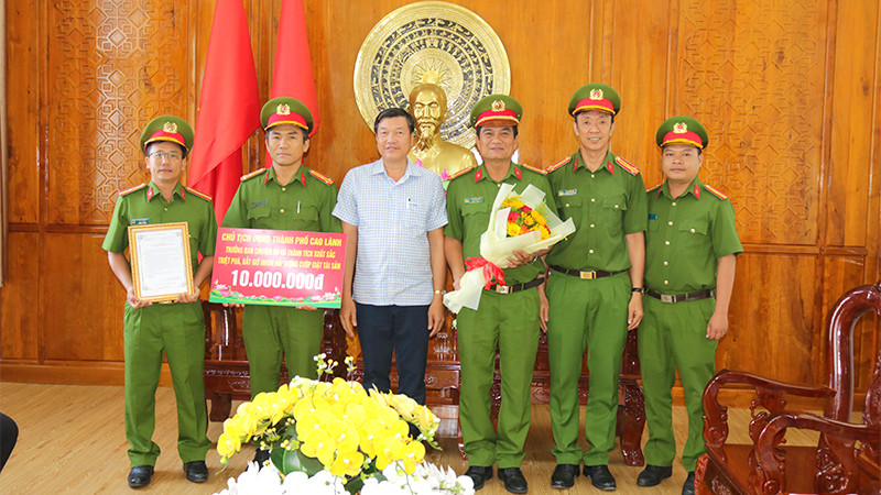 Chủ tịch Ủy ban nhân dân thành phố Cao Lãnh Võ Phan Thành Minh trao thưởng cho Ban chuyên án. (Ảnh: PHƯỚC THANH)