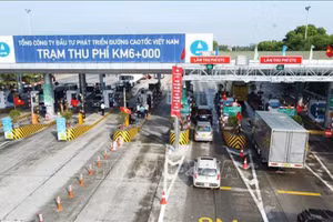Các phương tiện đã dán thẻ VETC lưu thông qua làn thu phí tự động ETC tại trạm thu phí BOT Nội Bài-Lào Cai. (Ảnh: TTXVN)