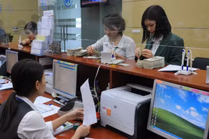 Tỷ giá chưa có biến động quá mạnh sau quyết định tăng lãi suất của FED. Ảnh: NAM ANH