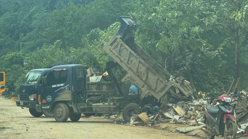 Xe chở chất thải được thu gom từ những tuyến đường bị ngập úng đổ trên vỉa hè đường Phùng Hưng, phường Hà Giang 2.