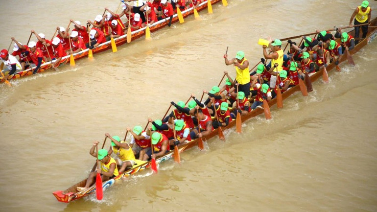 The men's boats race to reach the finish line first. 3-78.jpg