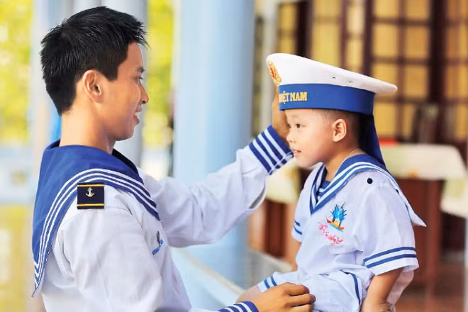 Chiến sĩ hải quân cùng em nhỏ trên đặc khu Trường Sa. (Ảnh: THẾ ĐẠI)
