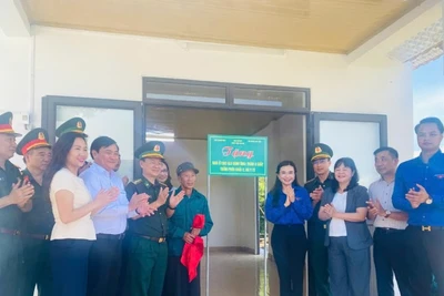 Cắt băng, trao nhà mới cho người dân.