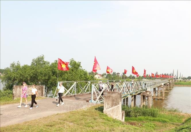 Du khách quốc tế tham quan cầu Hiền Lương - sông Bến Hải thuộc Di tích quốc gia đặc biệt Đôi bờ Hiền Lương - Bến Hải, tỉnh Quảng Trị. (Ảnh: TTXVN)