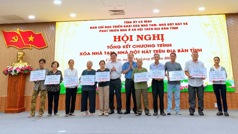 Bí thư Tỉnh ủy Cà Mau Nguyễn Hồ Hải (đứng giữa, áo sơ mi xanh) trao hỗ trợ sinh kế cho người dân tại hội nghị tổng kết chương trình xóa nhà tạm, nhà dột nát.