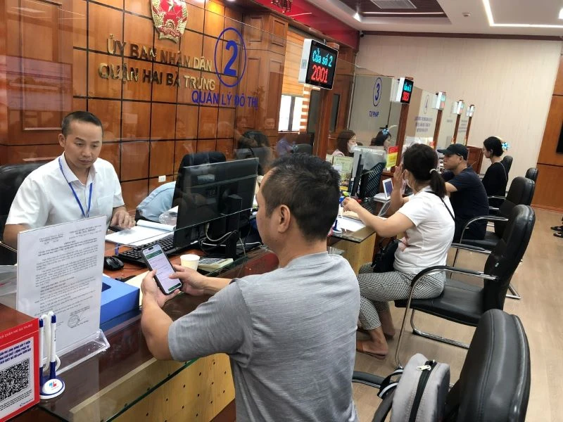 Cán bộ bộ phận Một cửa quận Hai Bà Trưng (Hà Nội) giải quyết thủ tục hành chính cho người dân. (Ảnh: BÍCH NGỌC)
