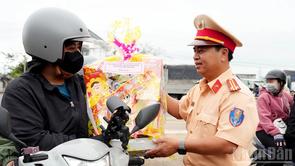 Đội Cảnh sát giao thông đường bộ số 3, Phòng Cảnh sát giao thông Công an tỉnh Lâm Đồng trao quà tặng người dân trên hành trình về quê đón Tết. 