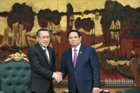 Thủ tướng Chính phủ Phạm Minh Chính và Bộ trưởng Lao động và Phúc lợi Lào Phosay Sayasone. (Ảnh: TRẦN HẢI) 