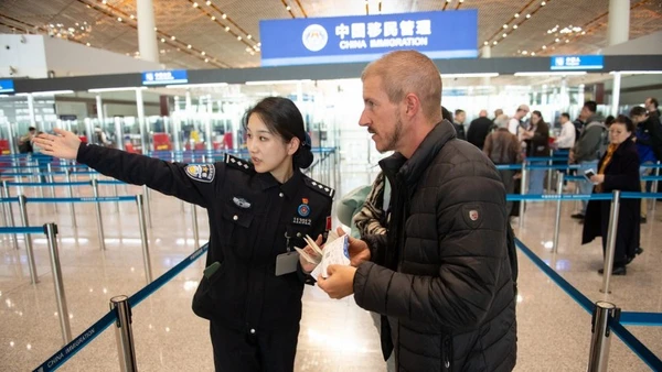 Du khách nước ngoài được chỉ dẫn vào làm thủ tục nhập cảnh tại sân bay thủ đô Bắc Kinh. (Ảnh: Nhân dân nhật báo)