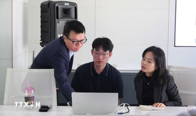 Ông Lê Quốc Minh, Ủy viên Trung ương Đảng, Tổng Biên tập Báo Nhân Dân, Chủ tịch Hội Nhà báo Việt Nam, trao đổi kinh nghiệm và trải nghiệm kỹ thuật làm báo với đại diện kỹ thuật làm báo AI của báo Hankook Ilbo. (Ảnh: ĐỨC THẮNG/TTXVN)