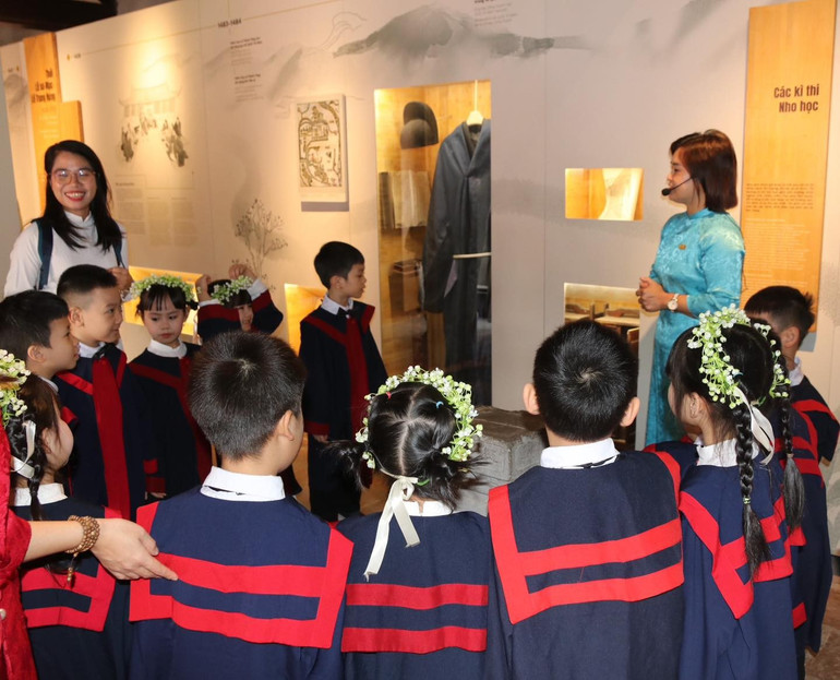 Các em học sinh tìm hiểu về truyền thống khoa bảng tại di tích Văn Miếu – Quốc Tử Giám. (Ảnh: Giang Nam) 5-8-van-hoa-15.jpg