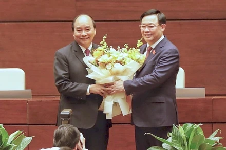 Chủ tịch Quốc hội Vương Đình Huệ tặng hoa, chúc mừng đồng chí Nguyễn Xuân Phúc. (Ảnh: ANH HUY)