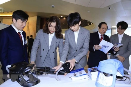 Nhóm các nhà sáng chế trẻ Vihelm với sản phẩm mũ chống Covid-19, là chiếc mũ bảo hộ che kín đường hô hấp, được bơm không khí liên tục qua một màng lọc khiến virus không thể lây xuyên qua. (Ảnh: Thống Nhất/TTXVN)