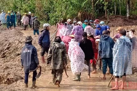 Người dân thôn 5 tập trung khắc phục lượng đất đá đổ xuống đường giao thông.