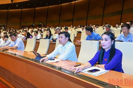 Đại biểu Quốc hội biểu quyết thông qua Nghị quyết về thí điểm mô hình tổ chức hoạt động lao động, hướng nghiệp, dạy nghề cho phạm nhân ngoài trại giam. (Ảnh: LINH NGUYÊN)