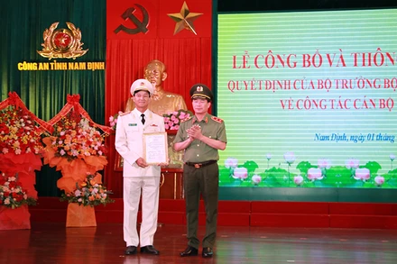 Trung tướng Lê Quốc Hùng, Thứ trưởng Công an, trao Quyết định của Bộ trưởng Công an về việc điều động, bổ nhiệm Đại tá Trần Minh Tiến giữ chức vụ Giám đốc Công an tỉnh Nam Định.