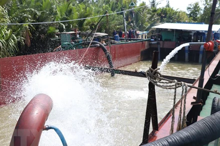 Bơm nước ngọt từ sà lan về Nhà máy nước xử lý. (Ảnh: TTXVN)