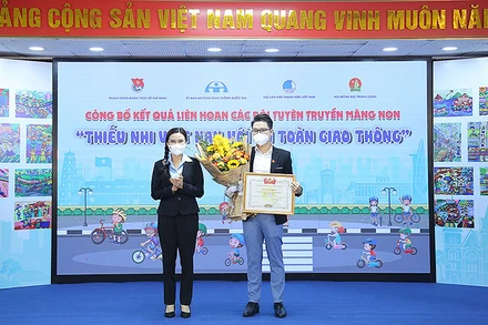 Bí thư Trung ương Đoàn TNCS Hồ Chí Minh Nguyễn Phạm Duy Trang, Chủ tịch Hội đồng Đội Trung ương (bên trái) trao giải Nhất tặng đại diện Trường Trung học cơ sở Võ Trường Toản (TP Dĩ An, tỉnh Bình Dương).