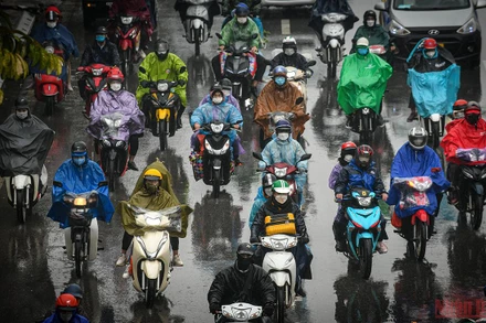 Người dân đội mưa lỉnh kỉnh đồ đạc trở về Hà Nội chiều 6/2/2022 (tức mùng 6 Âm lịch). (Ảnh: THÀNH ĐẠT)