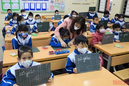 Giáo viên hướng dẫn các em học sinh lớp 1 vào lớp vì đây là lần đầu tiên các em được tới trường nên còn nhiều bỡ ngỡ. (Ảnh: THÀNH ĐẠT)