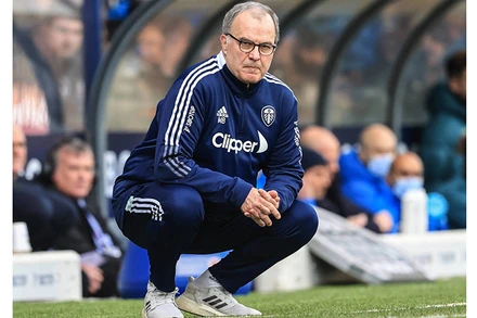 Marcelo Bielsa và dáng ngồi đặc trưng trên đường pitch. (Ảnh: SportIllustrated)