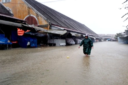 Chợ Hội An ngập nặng trong nước lũ. Mưa vẫn trút xuống liên tục kèm với gió.