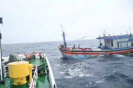 Tàu cá BĐ 98658 TS đang được lai dắt vào bờ